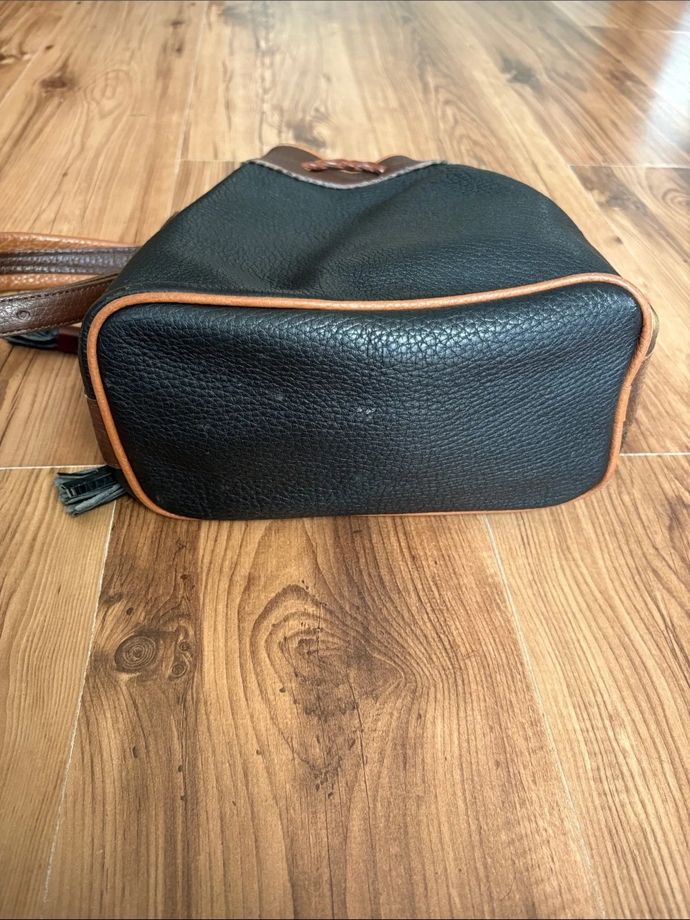Dooney & Bourke Black with Brown Trim Leather Drawstring Bucket Bag